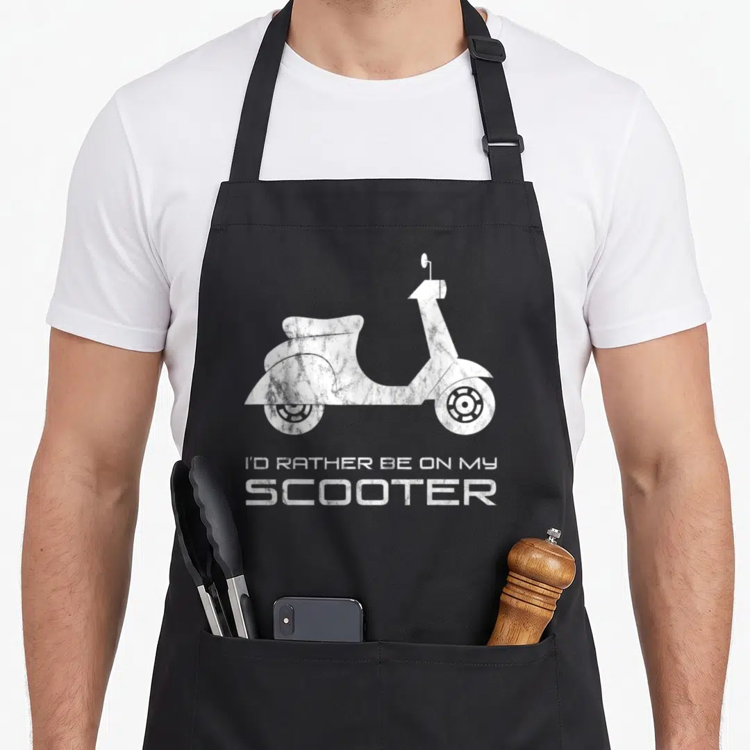 Rather scooter apron - White distressed scooter silhouette above stacked text reading I'D RATHER BE ON MY SCOOTER — shown on a black cotton canvas apron against a white background