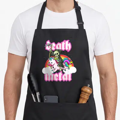 Blackcraft unicorn apron - Grim Reaper riding pink unicorn with rainbow and Death Metal text — shown on a black cotton canvas apron against a white background