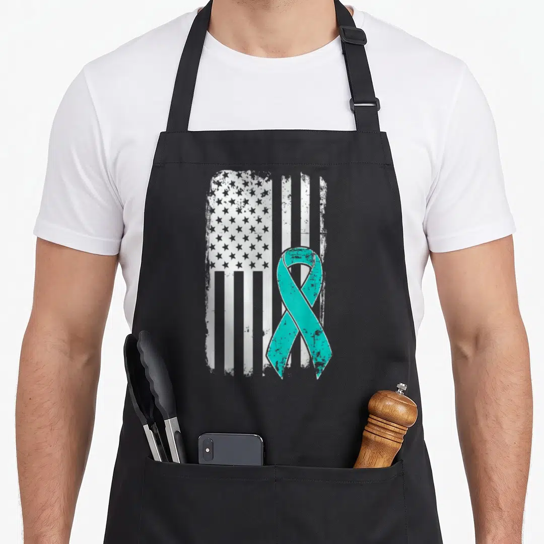 Ptsd american flag apron - Distressed white American flag with teal awareness ribbon overlay — shown on a black cotton canvas apron against a white background