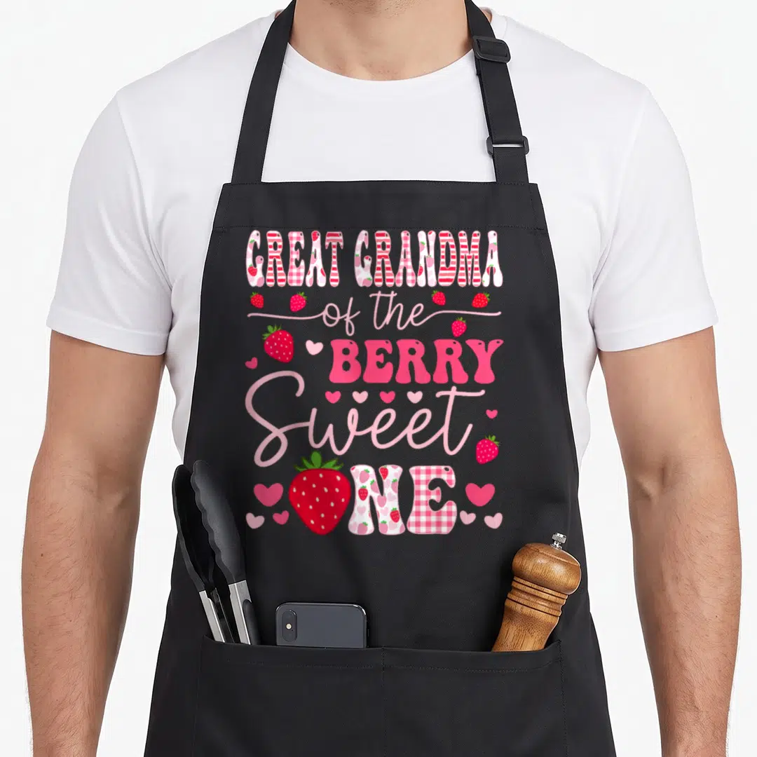 Berry great grandma apron - Stacked text reading Great Grandma of the Berry Sweet One surrounded by red strawberries — shown on a black cotton canvas apron against a white background