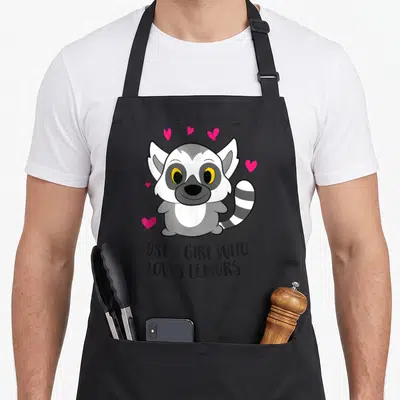 Cute lemur lover apron - Cartoon grey lemur with pink hearts and text Just a Girl Who Loves Lemurs — shown on a black cotton canvas apron against a white background