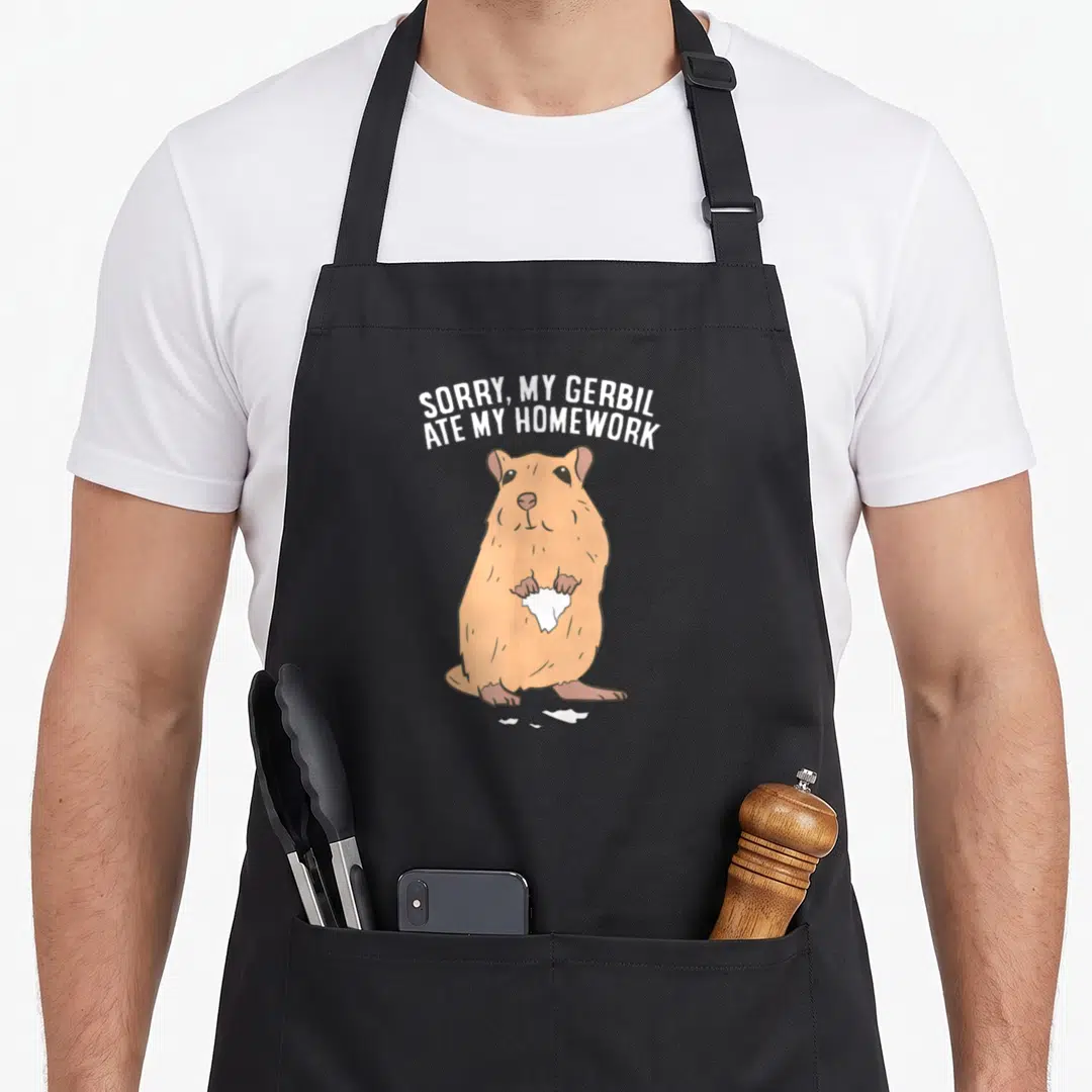 Owner gerbil lover apron - Tan gerbil holding torn white paper with arched text above — shown on a black cotton canvas apron against a white background