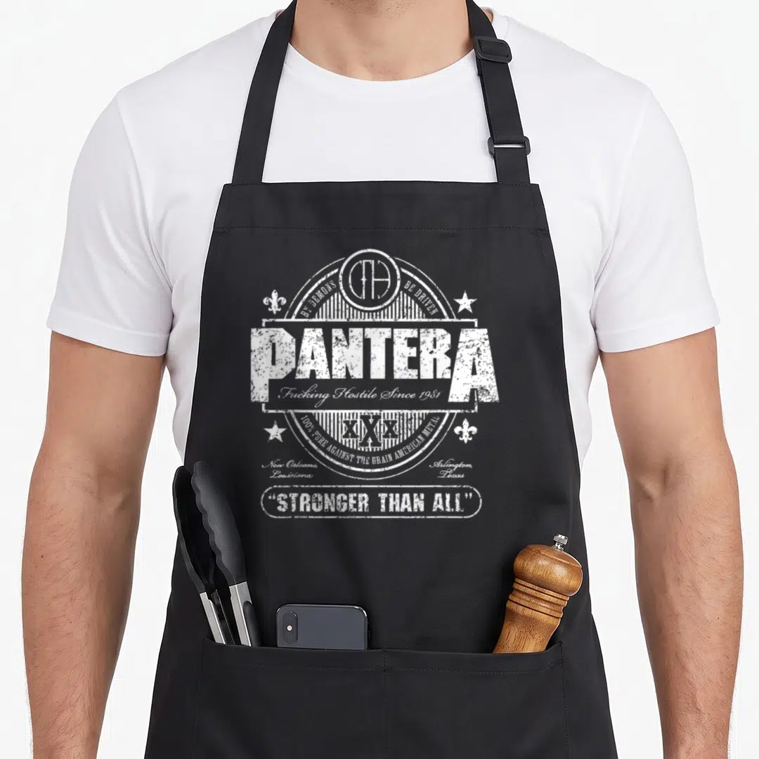 Pantera beer apron - Distressed white Pantera emblem with city names and STRONGER THAN ALL quote — shown on a black cotton canvas apron against a white background