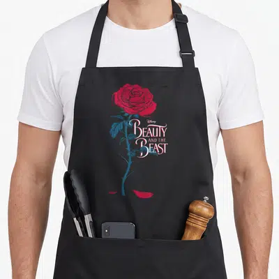 Beauty rose apron - Red rose blue stem Disney Beauty and the Beast text minimalist design — shown on a black cotton canvas apron against a white background