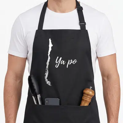 Chile po boy apron - White silhouette of Chile map next to Ya po script text — shown on a black cotton canvas apron against a white background