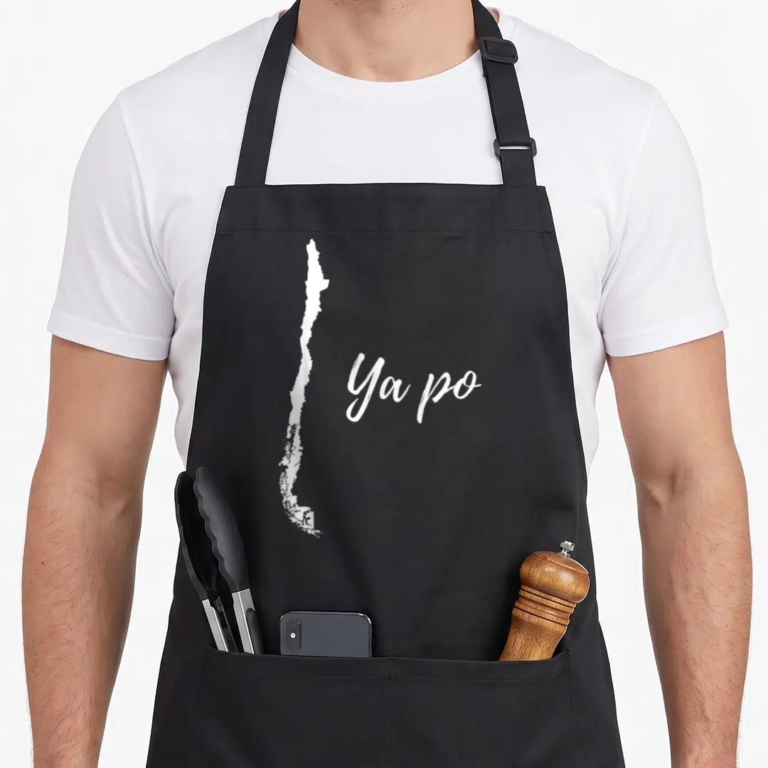 Chile po boy apron - White silhouette of Chile map next to Ya po script text — shown on a black cotton canvas apron against a white background