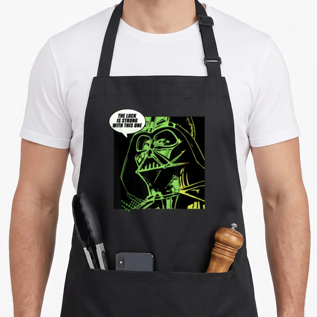 Luck st patrick day aprons - Retro Darth Vader portrait in black and lime green with speech bubble text — shown on a black cotton canvas apron against a white background