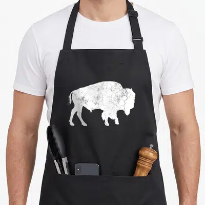 Distressed animal apron - White distressed bison silhouette on black bib apron — shown on a black cotton canvas apron against a white background