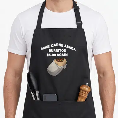 Carne asado apron - Three lines of white text above a silver foil burrito with brown filling — shown on a black cotton canvas apron against a white background