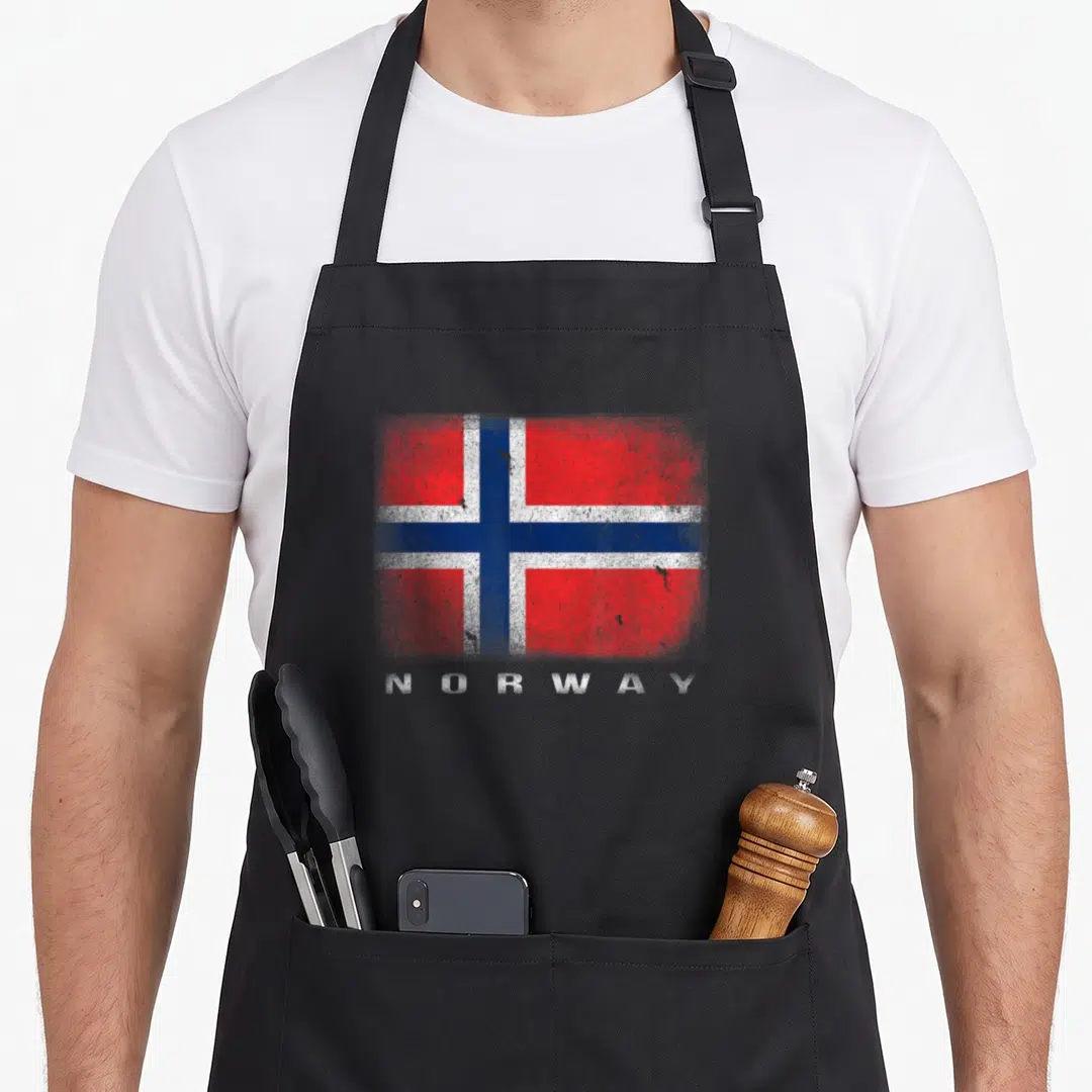 Norway norge norwegian kitchen aprons - Distressed red white and blue Norwegian flag with NORWAY text printed below — shown on a black cotton canvas apron against a white background