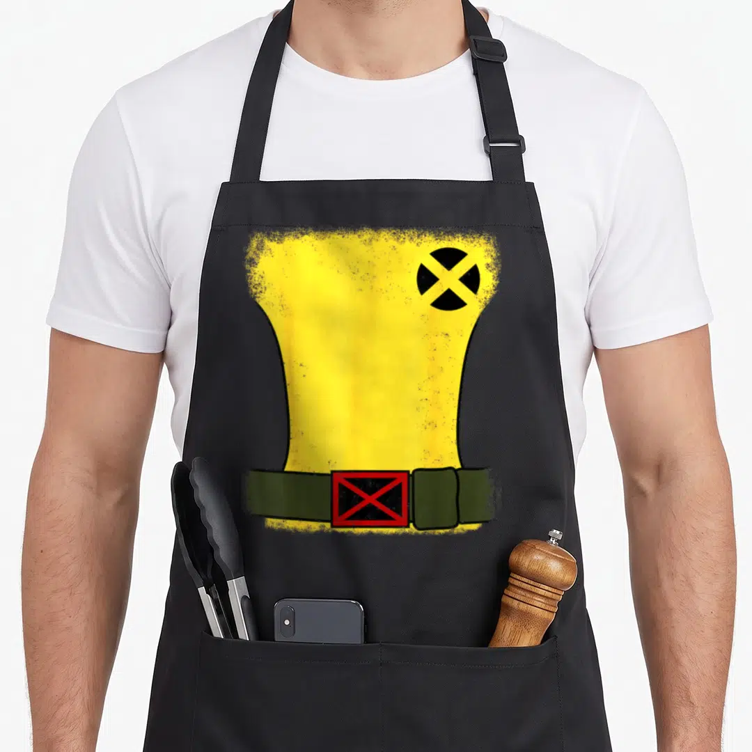 Rogue halloween white apron - Yellow torso shape with black circle and olive green belt with red buckle on black fabric — shown on a black cotton canvas apron against a white background