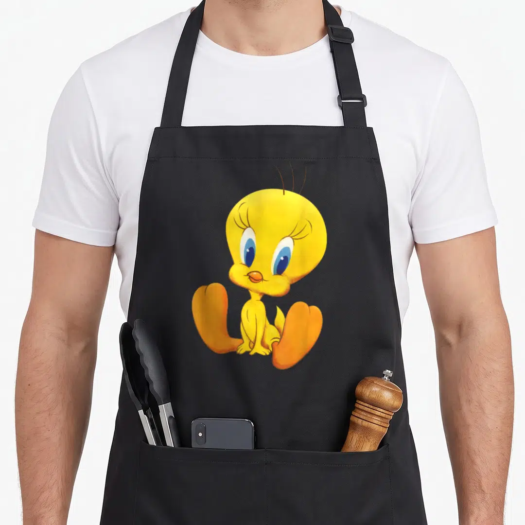Tweety crazy bunny man apron - Yellow cartoon bird sitting with orange feet and large blue eyes — shown on a black cotton canvas apron against a white background