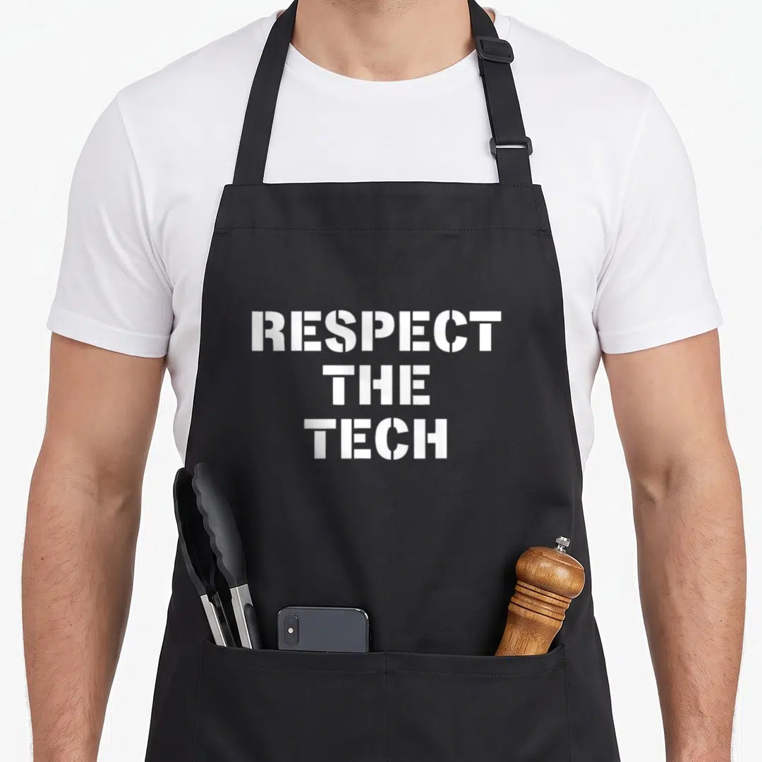 Technician theater apron - White stacked text reading RESPECT THE TECH on gray background — shown on a black cotton canvas apron against a white background