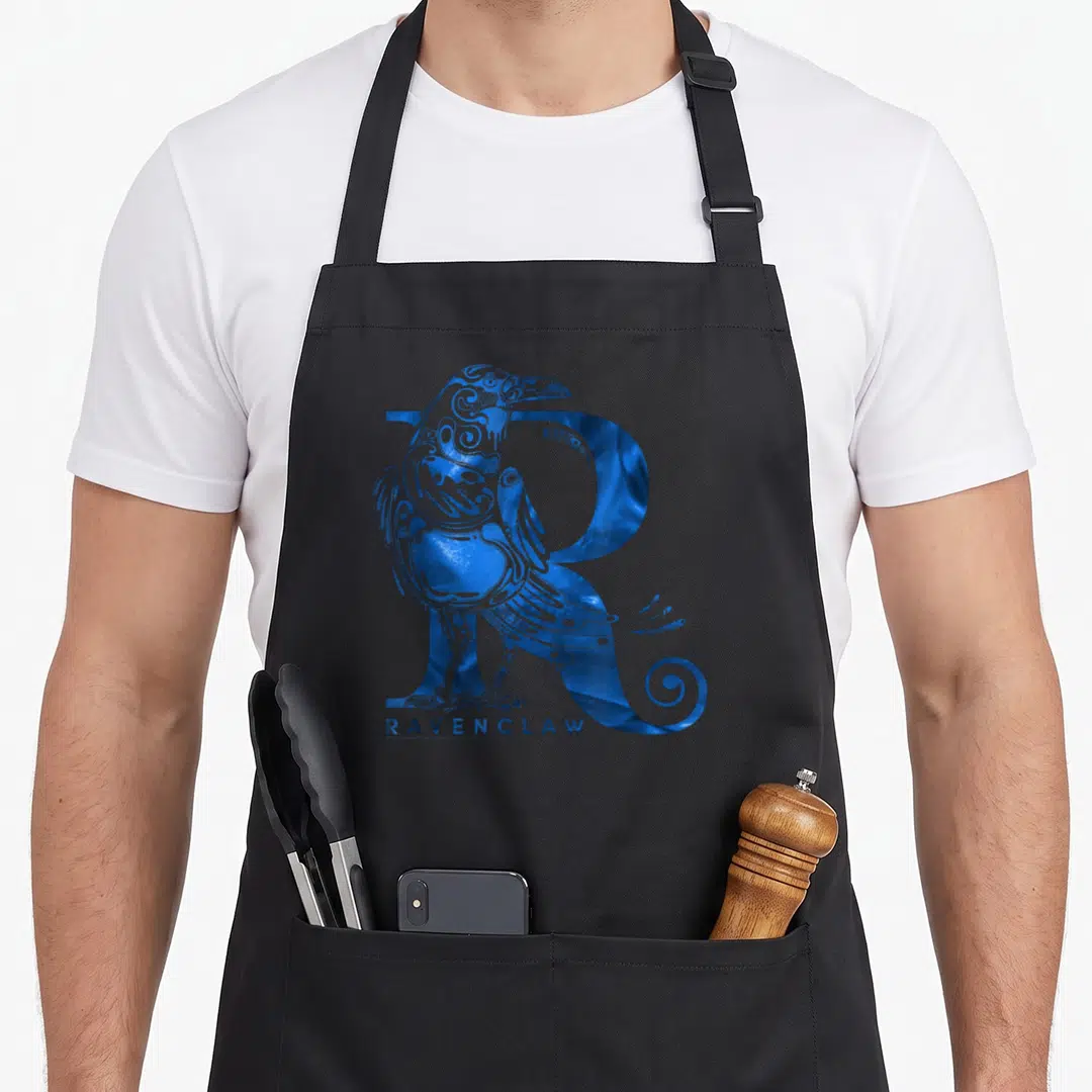 Funny ravenclaw apron - Blue stylized raven merged with large R and RAVENCLAW text in line art style — shown on a black cotton canvas apron against a white background