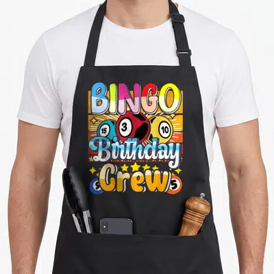 Bingo birthday apron - Colorful BINGO Birthday Crew design with numbered balls and stars — shown on a black cotton canvas apron against a white background