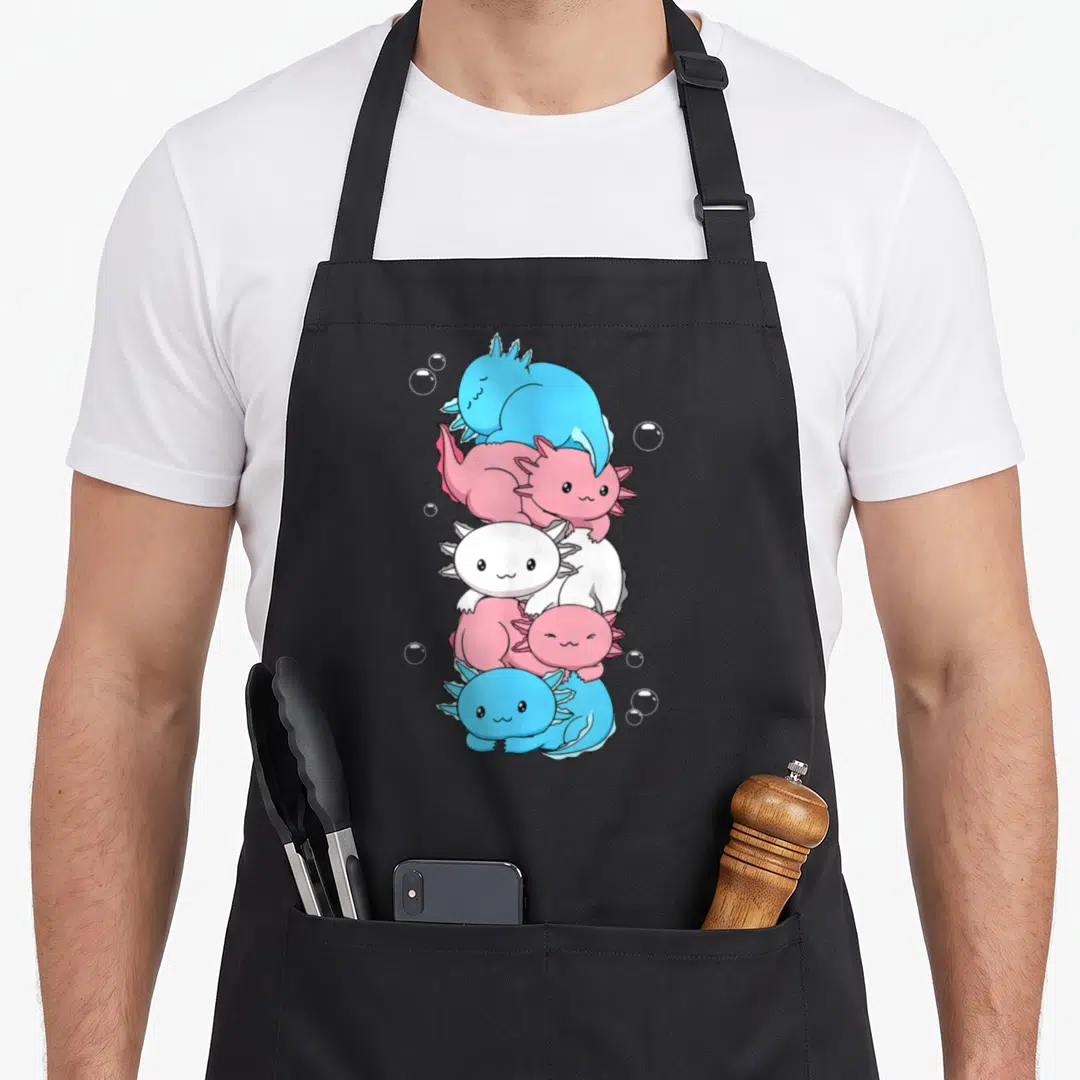 Transgender kawaii apron - Five cartoon axolotls stacked vertically in blue pink and white with bubbles — shown on a black cotton canvas apron against a white background