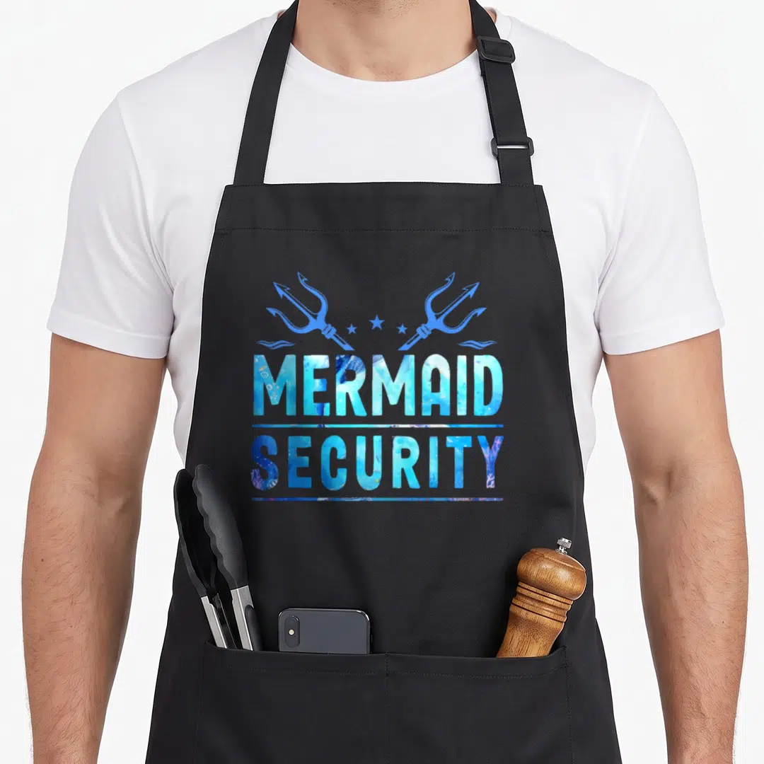 Security squad family aprons - MERMAID SECURITY text with two blue tridents and stars in watercolor style — shown on a black cotton canvas apron against a white background