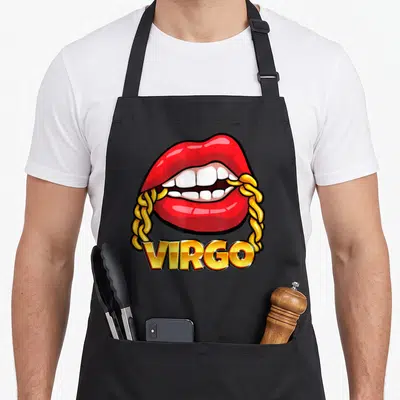 Lip zodiac aprons - Red cartoon lips biting a gold chain above gold VIRGO text — shown on a black cotton canvas apron against a white background
