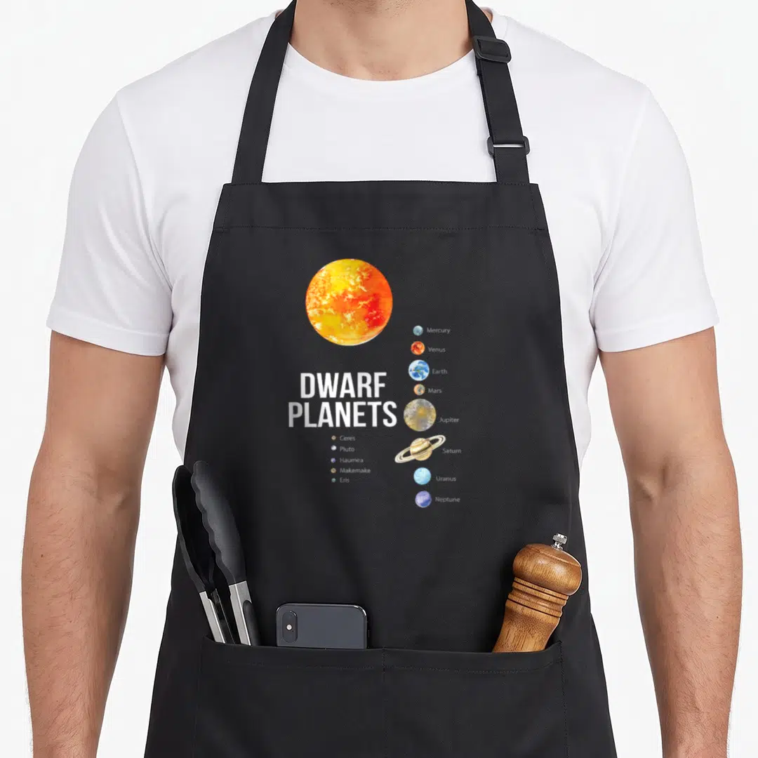Funny planet solar system apron - Large sun graphic next to vertical planet column and dwarf planets list in white text — shown on a black cotton canvas apron against a white background
