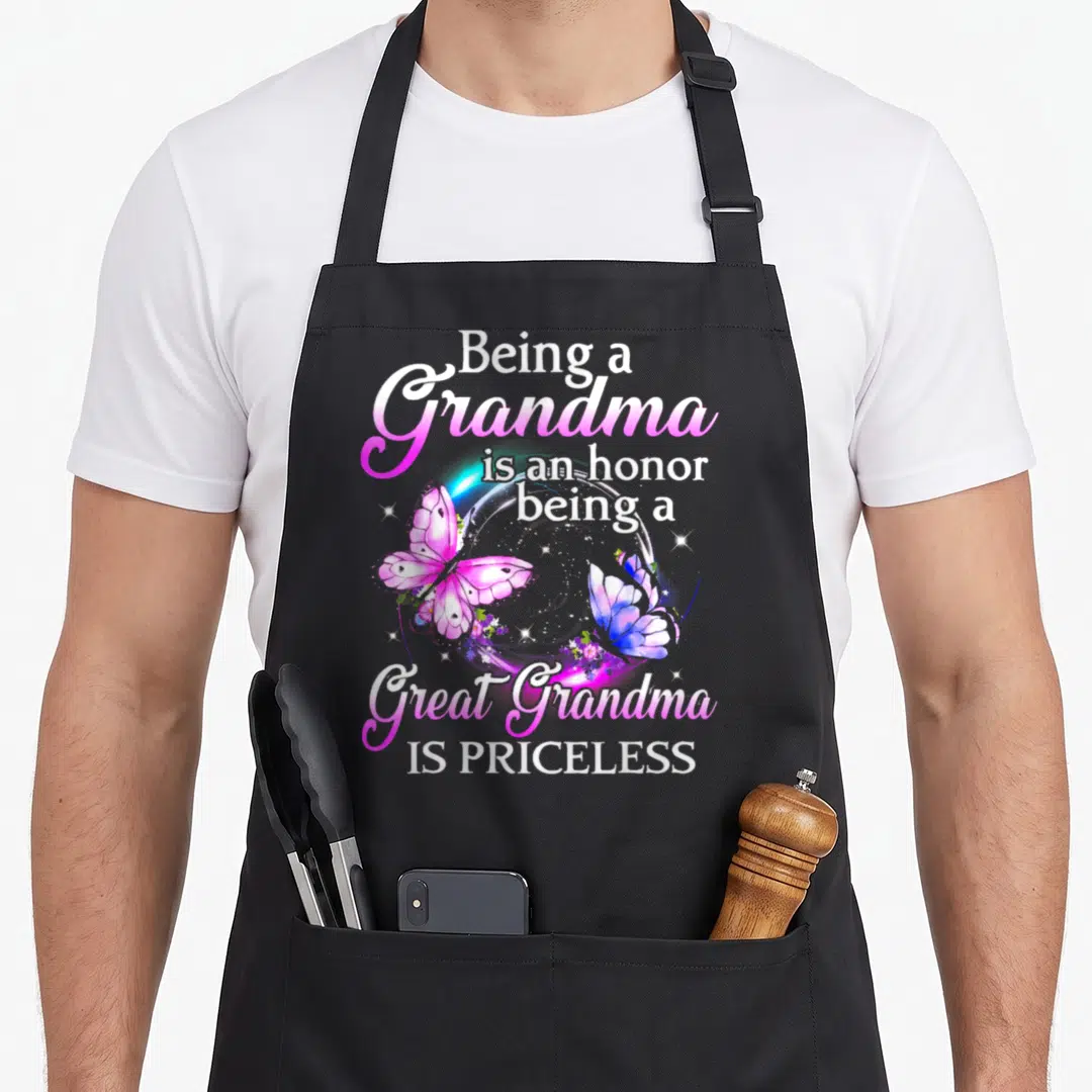 Honor great grandma apron - Two pink and blue watercolor butterflies inside a white circle with text about being — shown on a black cotton canvas apron against a white background