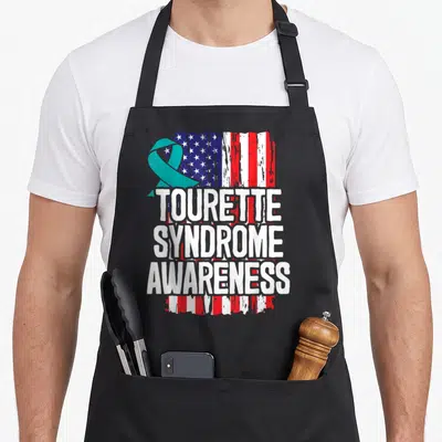 Tourette syndrome awareness ribbon apron - Distressed USA flag with teal ribbon and stacked white text reading TOURETTE — shown on a black cotton canvas apron against a white background