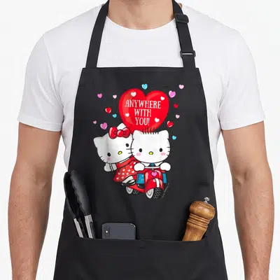 Dear valentine apron - Two white cartoon cats on a red scooter with a large red heart reading Anywhere With You — shown on a black cotton canvas apron against a white background