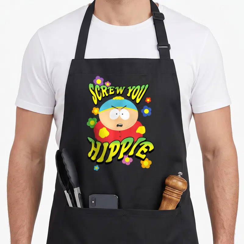 Screw hippie apron - Eric Cartman centered between SCREW YOU HIPPIE text with scattered yellow, green, red, and blue — shown on a black cotton canvas apron against a white background