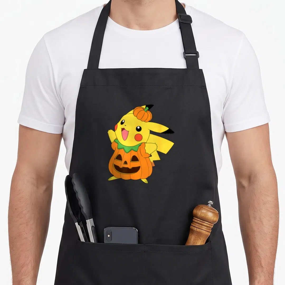 Pumpkin costume halloween kitchen aprons - Yellow cartoon character in orange pumpkin costume with small pumpkin on head — shown on a black cotton canvas apron against a white background