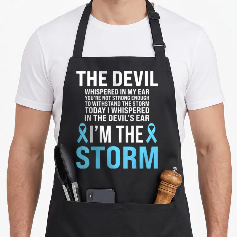 Awareness light ribbon apron - Stacked white text reading I'm The Storm flanked by two light blue awareness ribbons — shown on a black cotton canvas apron against a white background
