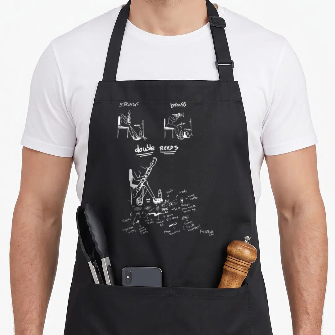 Fagotina bassoon apron - White line art comparing calm string and brass musicians to a cluttered double reed player — shown on a black cotton canvas apron against a white background