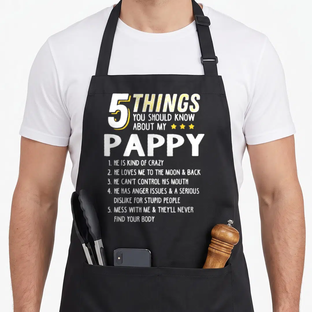 Funny pappy grandpa apron - 5 Things You Should Know About My Pappy text with three yellow stars between lines 3 and 4 — shown on a black cotton canvas apron against a white background