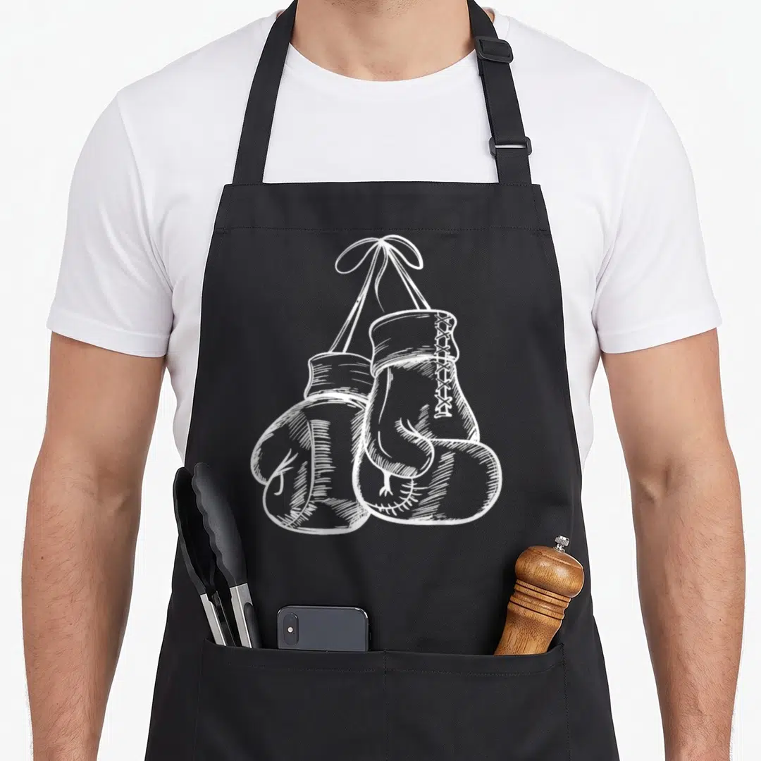 Boxer gloves and apron - Two white boxing gloves hanging by laces in a line-art sketch style — shown on a black cotton canvas apron against a white background