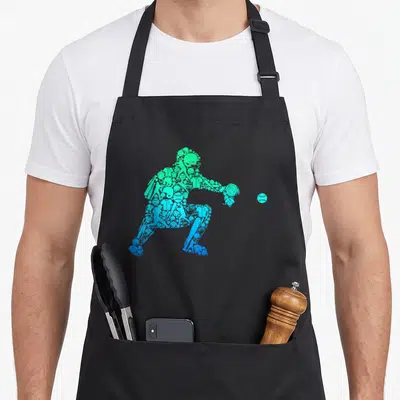 Youth baseball apron - Catcher silhouette formed by green and blue baseball equipment icons with a ball — shown on a black cotton canvas apron against a white background