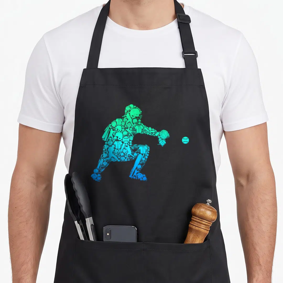 Youth baseball apron - Catcher silhouette formed by green and blue baseball equipment icons with a ball — shown on a black cotton canvas apron against a white background