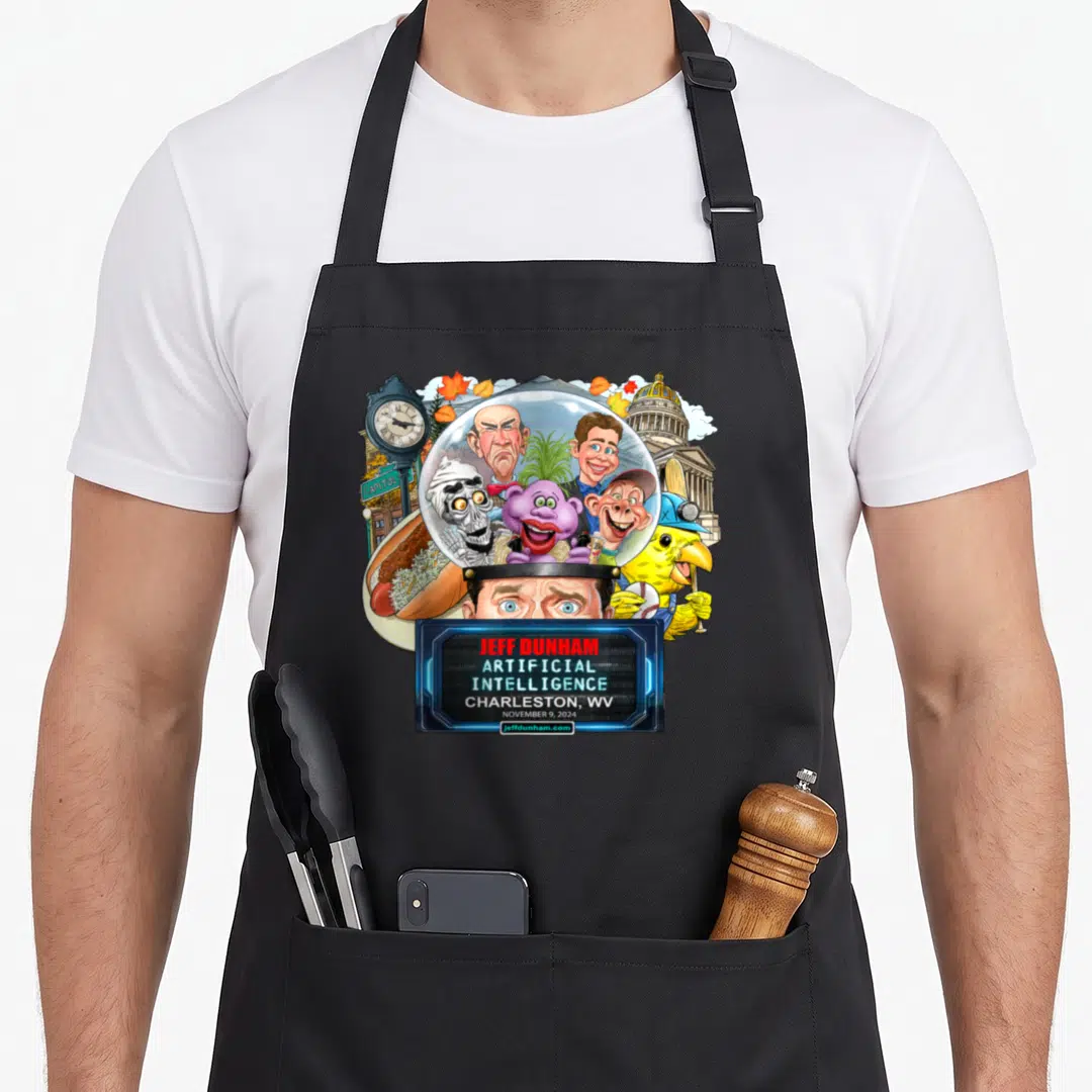 Dunham charleston apron - Jeff Dunham caricatures in crystal ball above eyes with clock hot dog and blue text frame — shown on a black cotton canvas apron against a white background