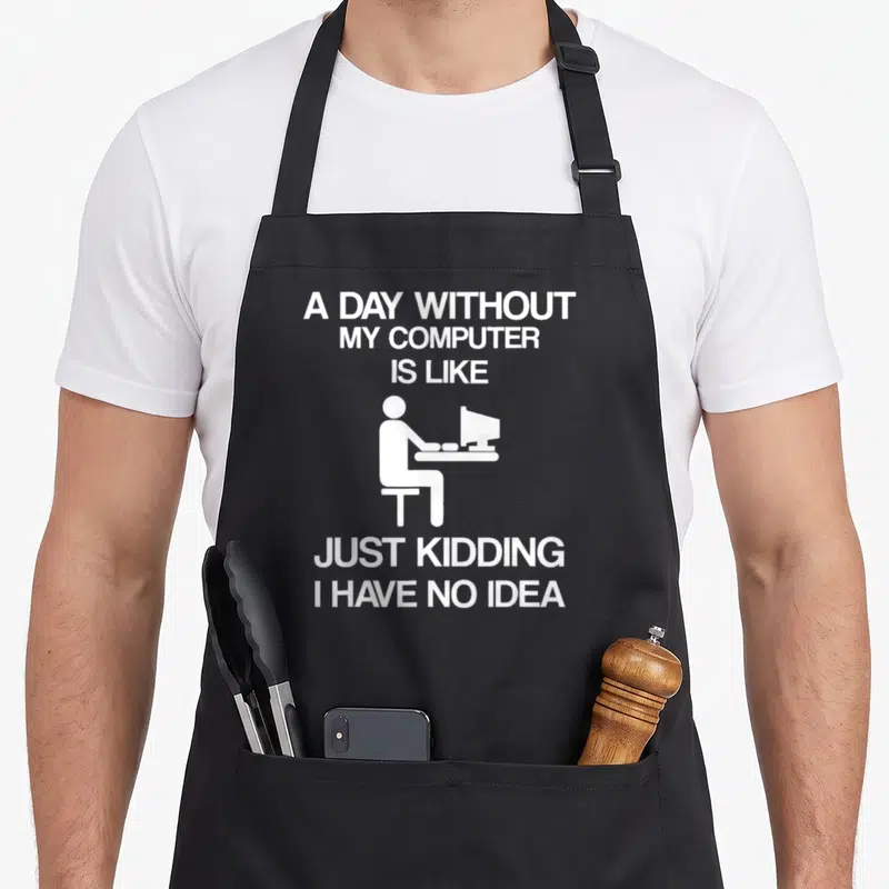 Computer table addict apron - White text and seated person silhouette on black background — shown on a black cotton canvas apron against a white background