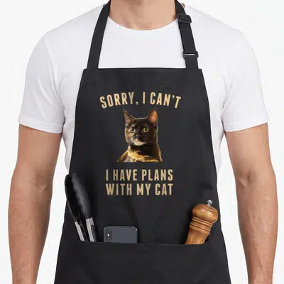 Plan tortoiseshell cat apron - Tortoiseshell cat photo with Sorry I Can't I Have Plans With My Cat text — shown on a black cotton canvas apron against a white background