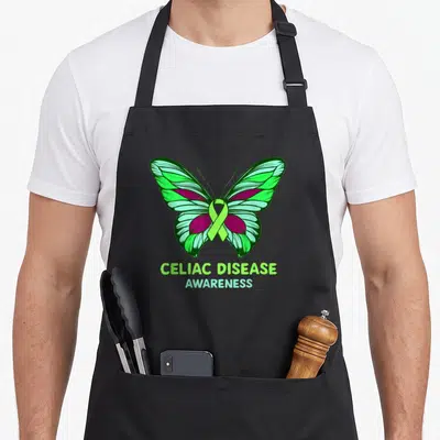 Celiac disease ribbon apron - Cartoon butterfly with green purple wings and lime ribbon above Celiac Disease Awareness — shown on a black cotton canvas apron against a white background
