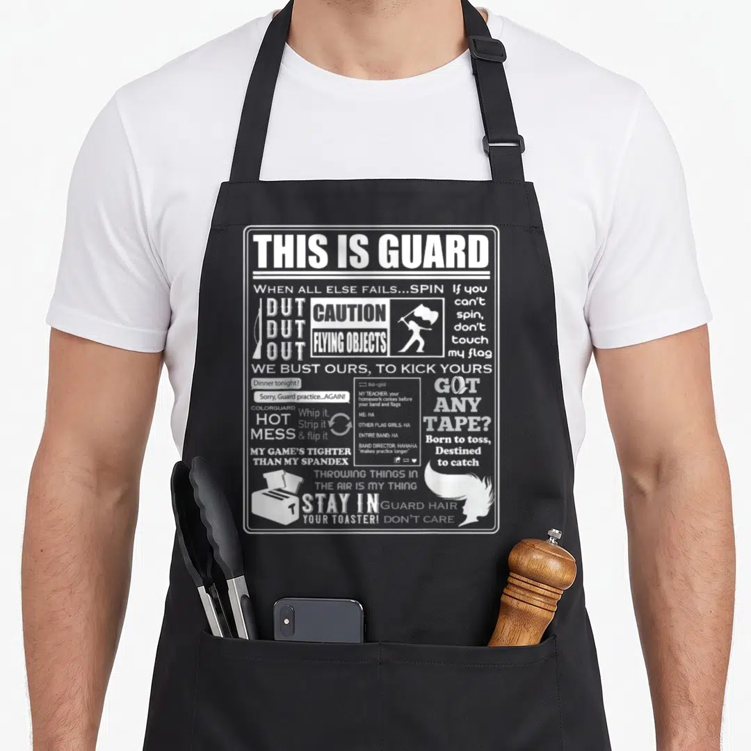 Guard meme apron - White text collage reading THIS IS GUARD CAUTION FLYING OBJECTS STAY IN YOUR TOASTER with icons — shown on a black cotton canvas apron against a white background