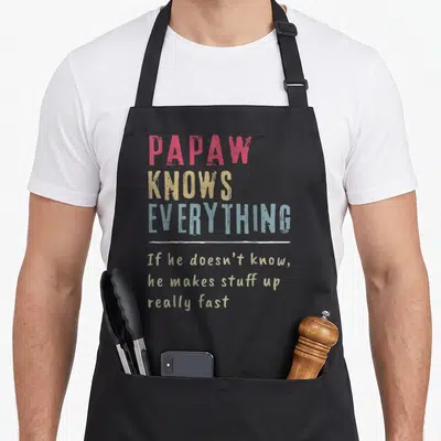 Papaw grandpa apron - Stacked red yellow and blue text reading Papaw Knows Everything with a handwritten disclaimer — shown on a black cotton canvas apron against a white background