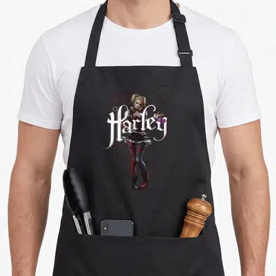 Knight vehicle apron - Realistic Harley Quinn holding dice with white script text and red hearts — shown on a black cotton canvas apron against a white background