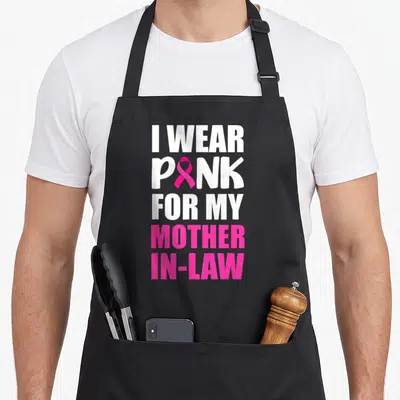 Mother ribbon apron - Stacked text I WEAR PINK FOR MY MOTHER IN-LAW with pink ribbon replacing I — shown on a black cotton canvas apron against a white background
