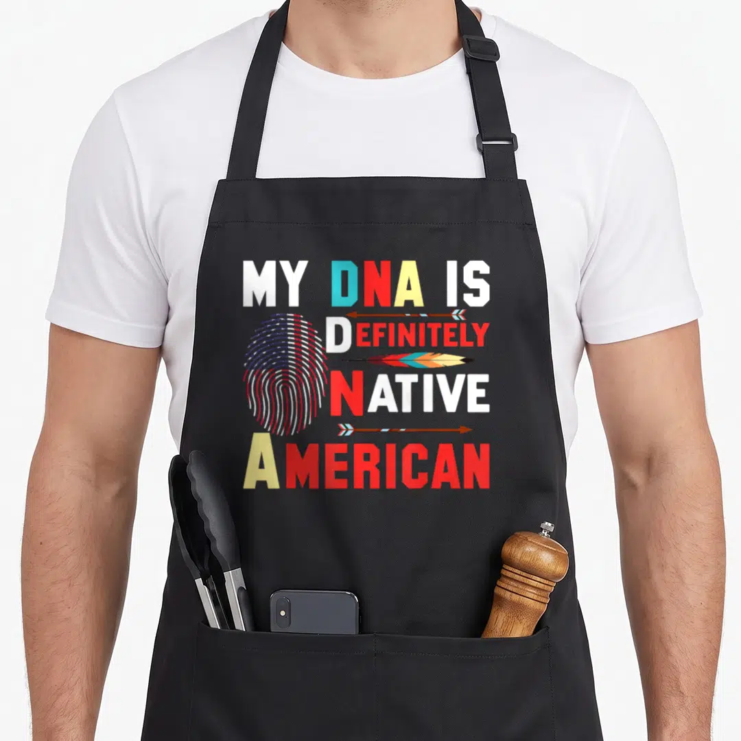 Definitely native american aprons - Stacked text My DNA Is Definitely Native American with flag fingerprint, arrows — shown on a black cotton canvas apron against a white background