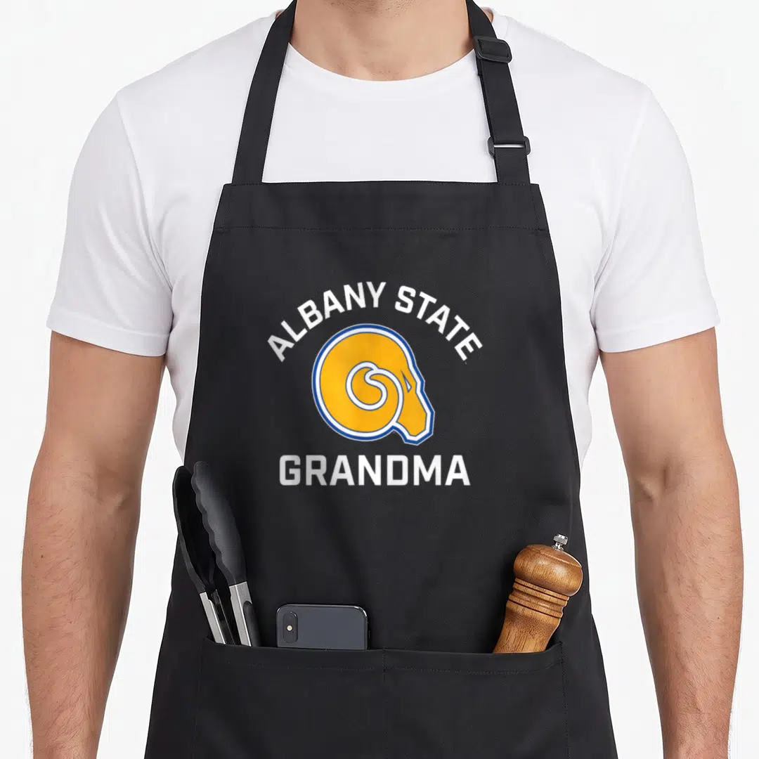 Albany grandma apron - Yellow ram head logo with arched ALBANY STATE and straight GRANDMA text in white and blue — shown on a black cotton canvas apron against a white background