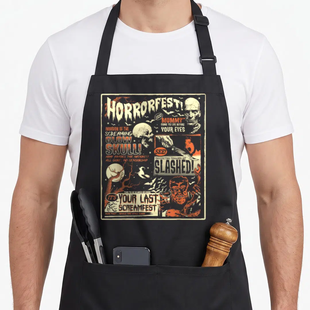 Horrorfest halloween apron - Vintage horror poster collage with distressed text and skull imagery in beige orange white — shown on a black cotton canvas apron against a white background