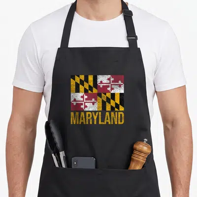 Annapolis maryland eastern apron - Distressed Maryland state flag with yellow MARYLAND text below on black fabric — shown on a black cotton canvas apron against a white background