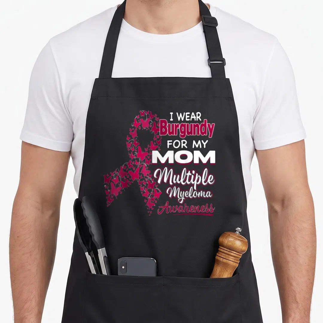Multiple ribbon mom apron - I WEAR BURGUNDY FOR MY MOM text beside a ribbon made of burgundy butterflies — shown on a black cotton canvas apron against a white background