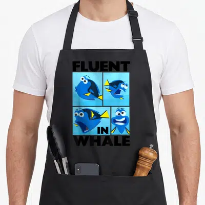 Finding box apron - Four Dory expression panels with fluent in whale text in blue black yellow — shown on a black cotton canvas apron against a white background