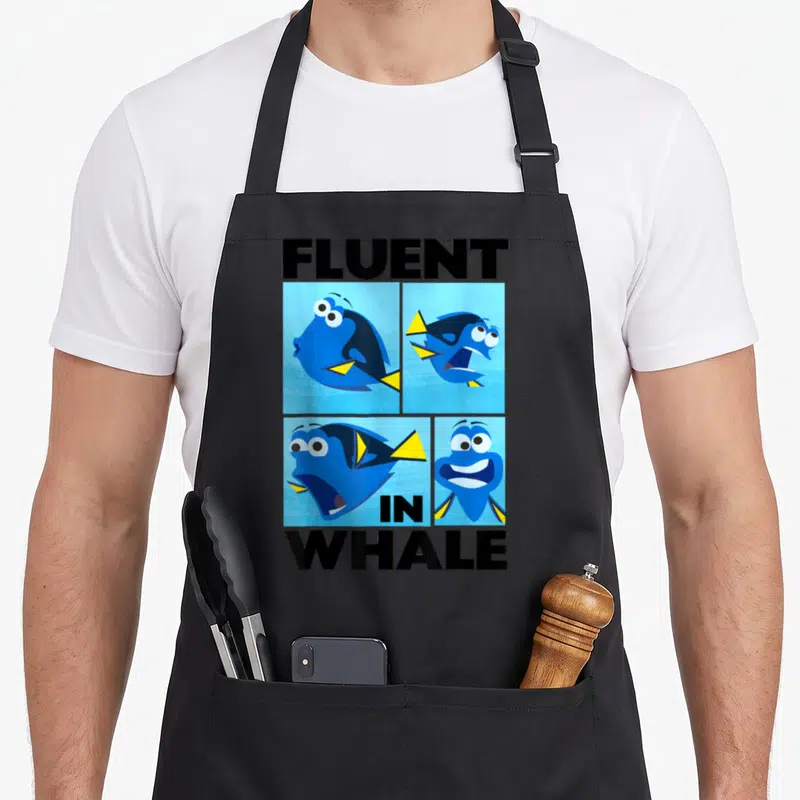 Finding box apron - Four Dory expression panels with fluent in whale text in blue black yellow — shown on a black cotton canvas apron against a white background