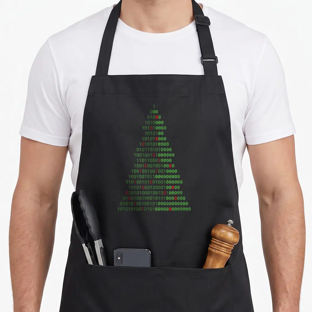 Binary christmas tree apron - Stacked binary code in green and red forming a triangular Christmas tree shape — shown on a black cotton canvas apron against a white background